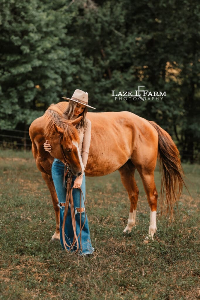 cowgirl standing beside a horse during an equine photoshoot with Laze L Farm Photography