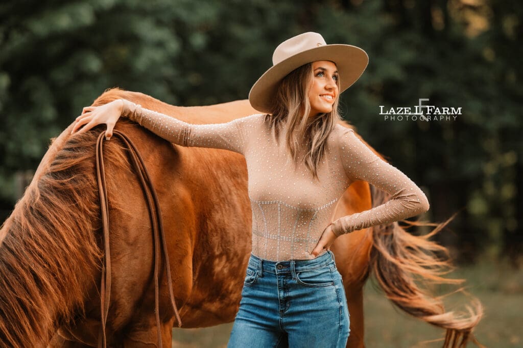 cowgirl standing beside a horse during an equine photoshoot with Laze L Farm Photography