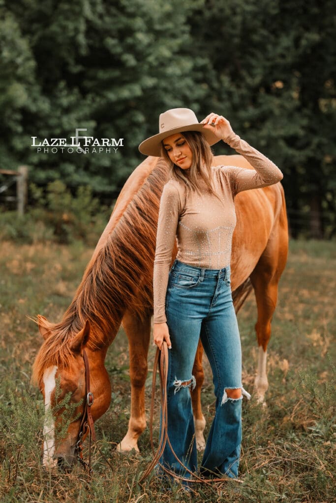cowgirl standing beside a horse during an equine photoshoot with Laze L Farm Photography