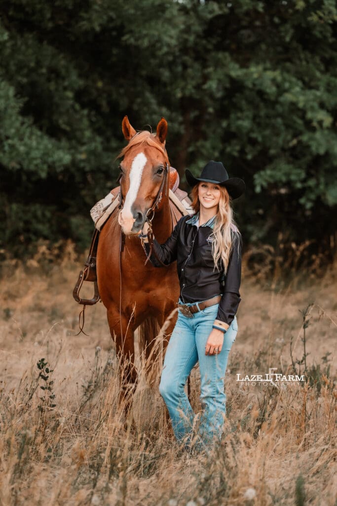 A cowgirl and her horse in a field during a photoshoot with Laze L Farm Photography