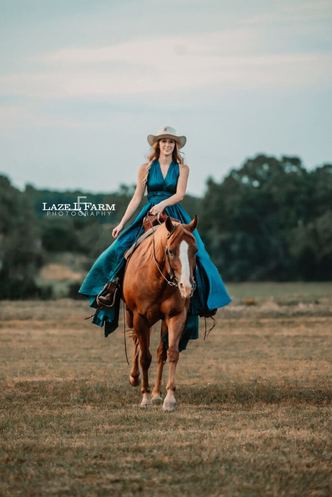Cowgirl in a turquoise parachute dress at sunset with her horse during a photoshoot with Laze L Farm Photography