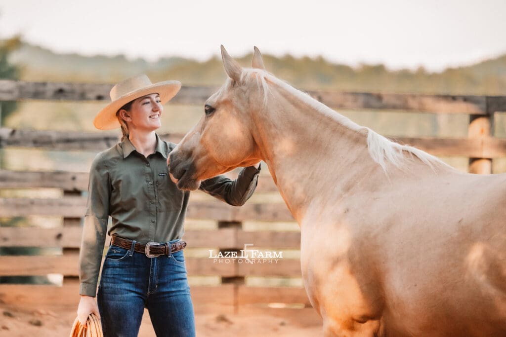 Cowgirl working her horse in the round pen during a photoshoot with Laze L Farm Photography