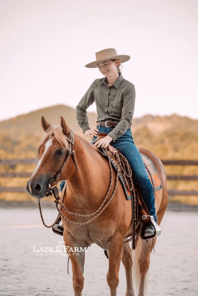 Cowgirl working her horse in the round pen during a photoshoot with Laze L Farm Photography