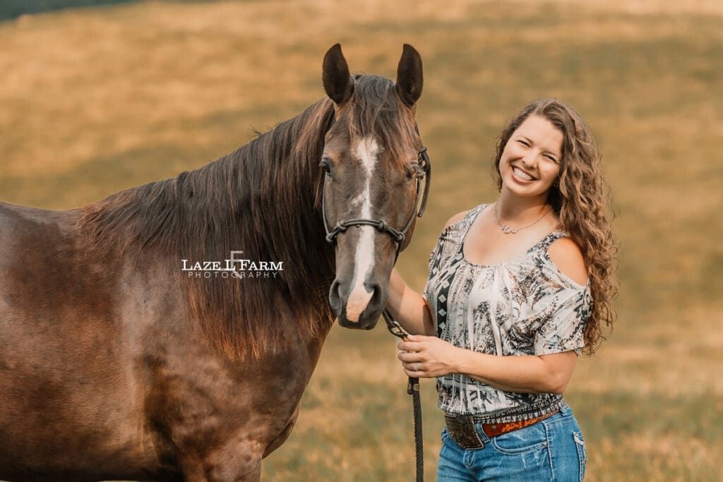 A girl with her horse in a field during a photoshoot with Laze L Farm Photography