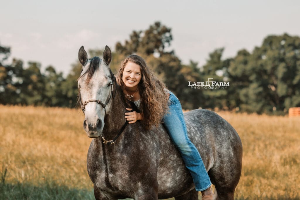 A girl riding her horse in a field during a photoshoot with Laze L Farm Photography