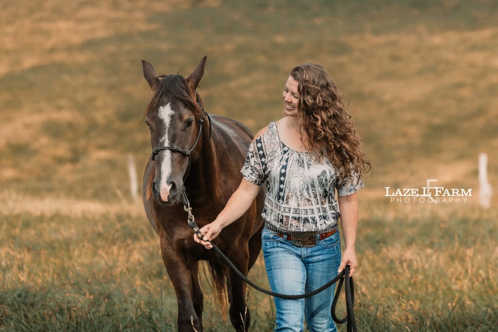 A girl with her horse in a field during a photoshoot with Laze L Farm Photography