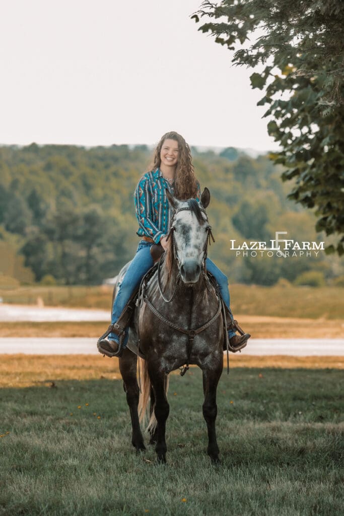 A girl riding her horse in a field during a photoshoot with Laze L Farm Photography