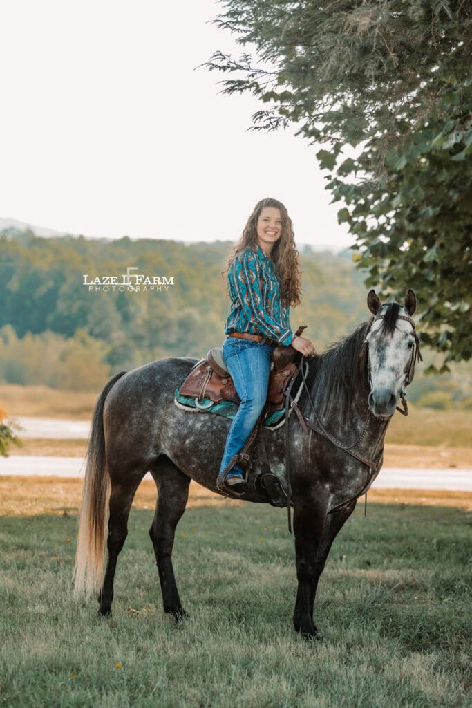 A girl riding her horse in a field during a photoshoot with Laze L Farm Photography