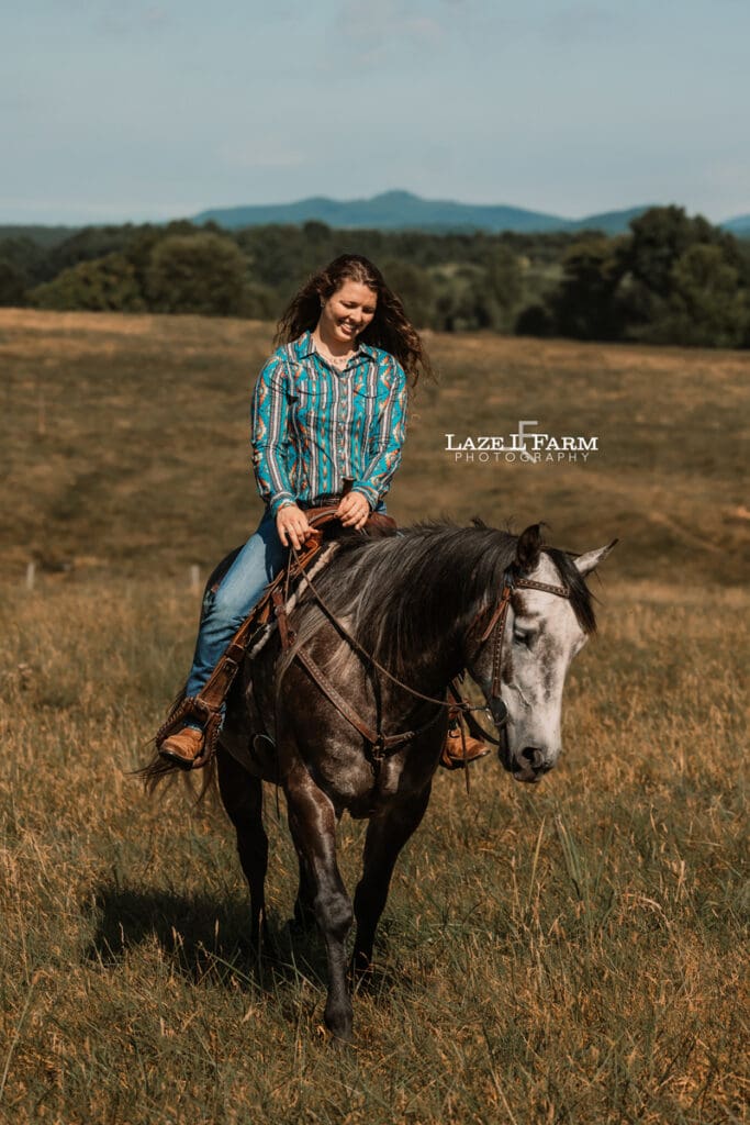 A girl riding her horse in a field during a photoshoot with Laze L Farm Photography