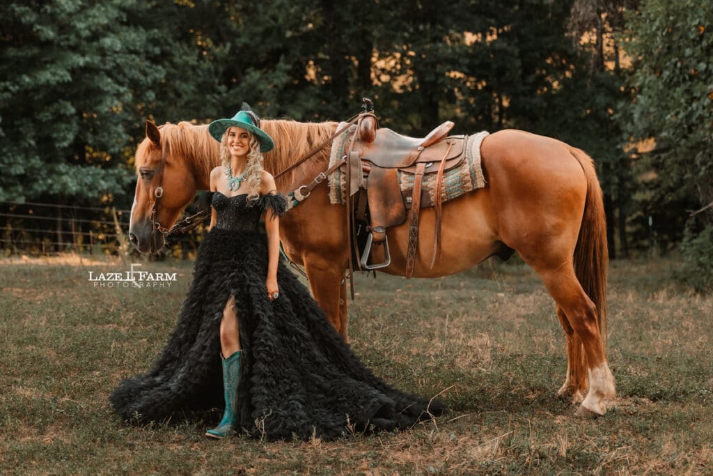a girl in a black dress standing beside a horse in a field at sunset  during a photoshoot with Laze L Farm Photography in Taylorsville NC