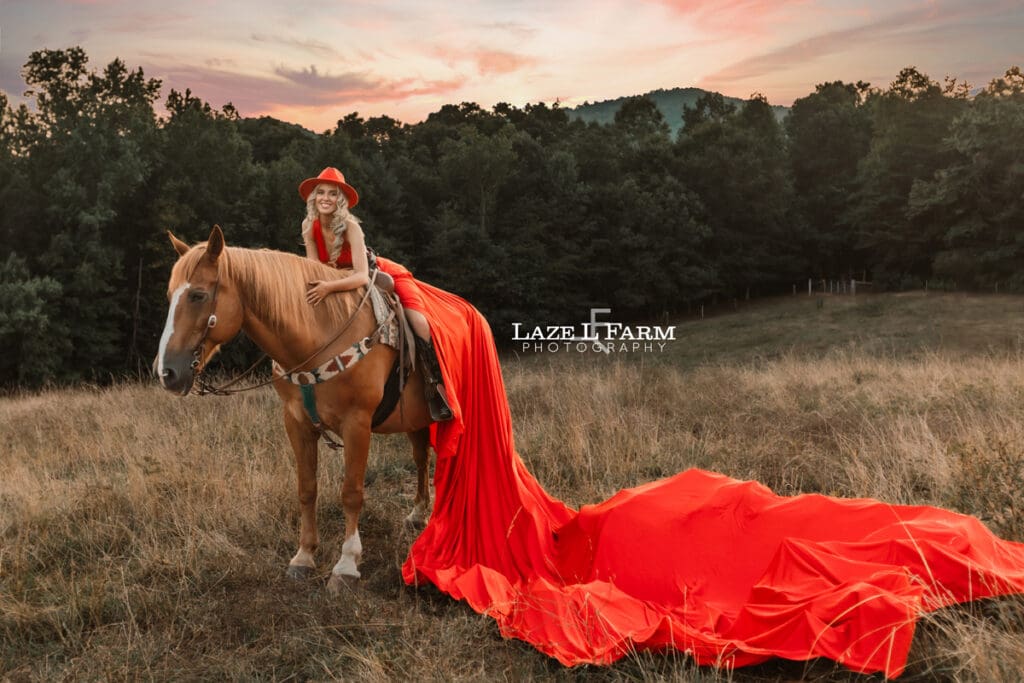 a girl in a red parachute dress at sunset with a horse in a field  during a photoshoot with Laze L Farm Photography in Taylorsville NC