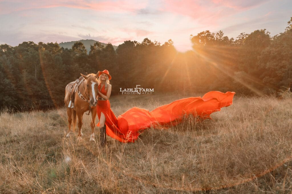 a girl in a red parachute dress at sunset with a horse in a field  during a photoshoot with Laze L Farm Photography in Taylorsville NC