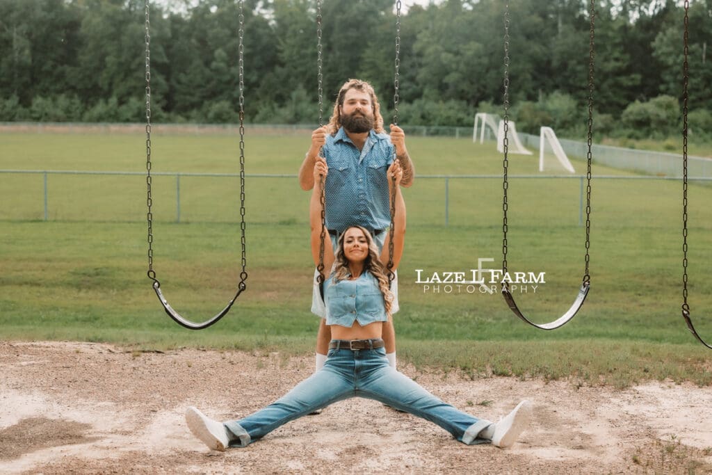 Bailey and Marcus recreate a funny engagement photo pose inspired by Masterminds on a playground